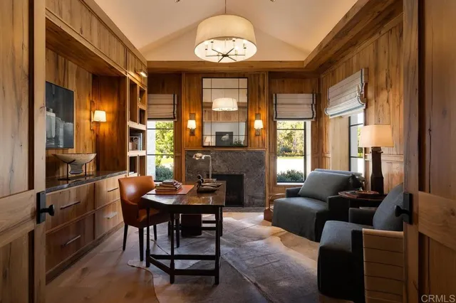 a living room with fireplace furniture and a large window