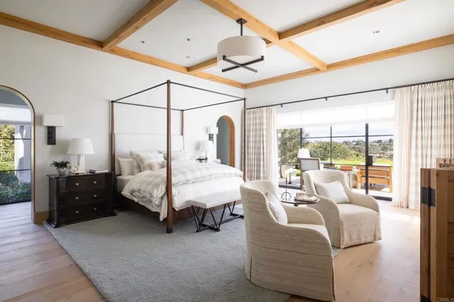 a bed room with furniture and a large window