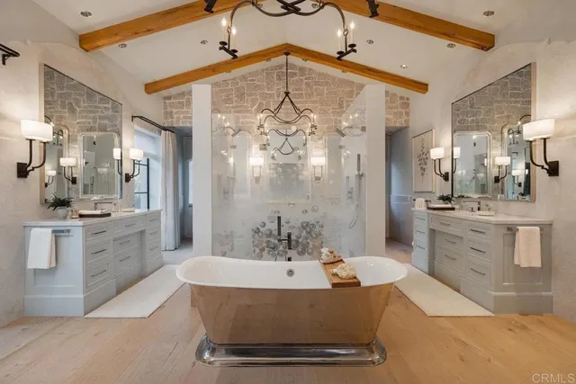 a spacious bathroom with a double vanity sink a mirror and a bathtub