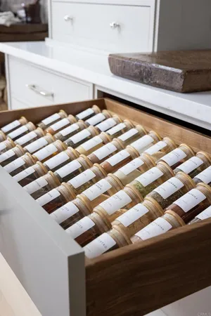 a kitchen with stainless steel appliances granite countertop a lot of cabinets and wooden floor