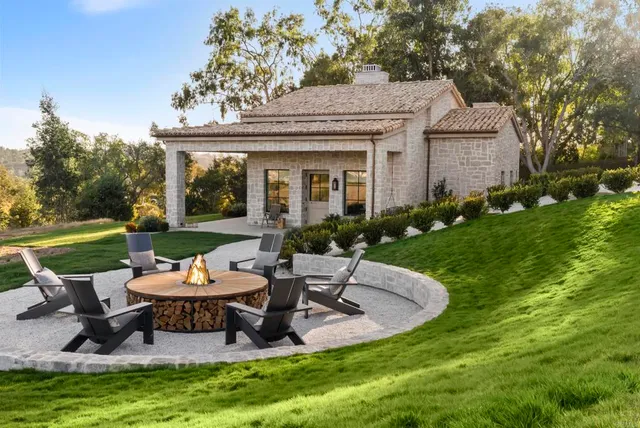 a view of a house with backyard sitting area and garden