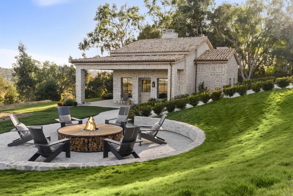 17845 Via De Fortuna Rancho Santa Fe, CA 92067 - Photo 15 of 20 a view of a house with backyard sitting area and garden