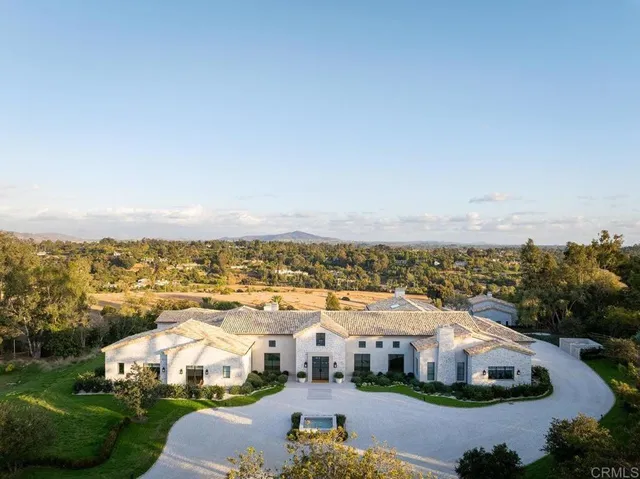 an aerial view of residential houses with outdoor space and swimming pool