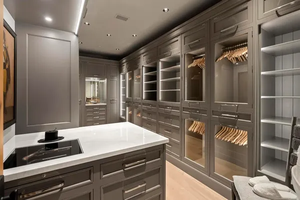 a view of hall way with mirror and furniture