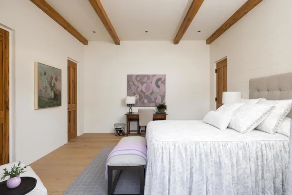 a view of a swimming pool and lounge chairs in back yard of the house
