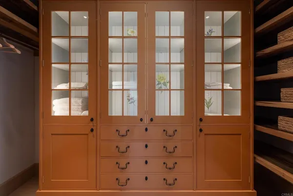 a front view of a house with garden and chairs