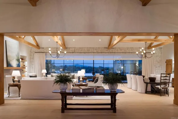 a living room with furniture and a chandelier