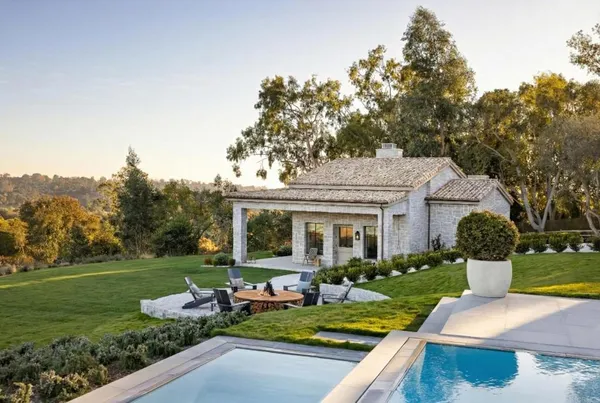 a view of a house with backyard porch and sitting area