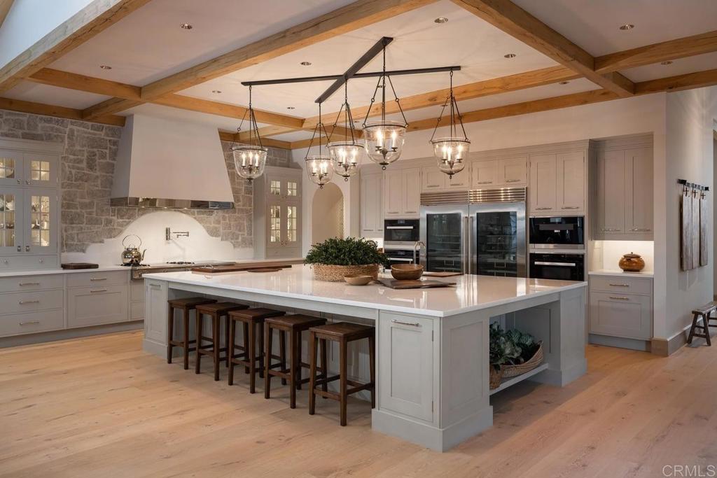17845 Via De Fortuna Rancho Santa Fe, CA 92067 - Photo 8 of 20 a kitchen with a stove and a table