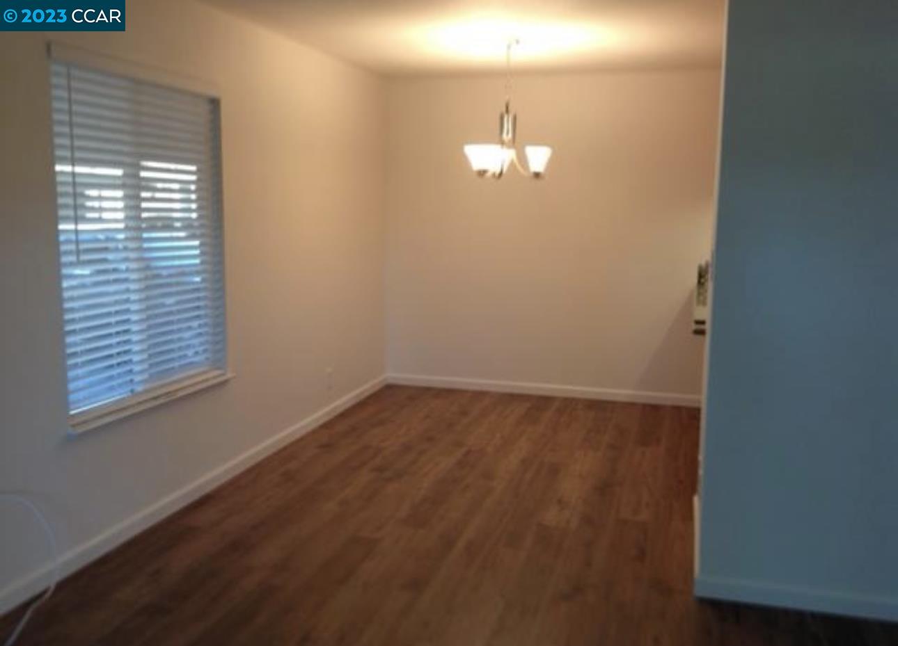 2019 Olivera Road, Unit B Concord, CA 94520 - Photo 7 of 7 a view of empty room with wooden floor and window
