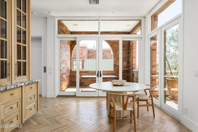 a living room with furniture and large windows