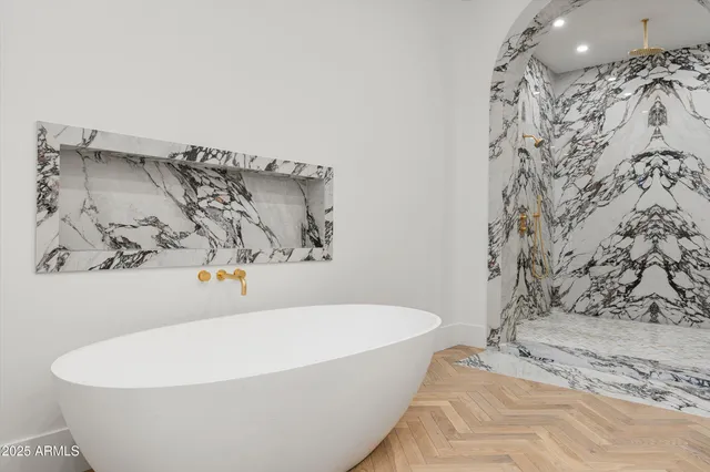 a white bath tub sitting in a bathroom