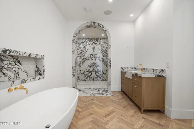 a bathroom with a bathtub sink and mirror