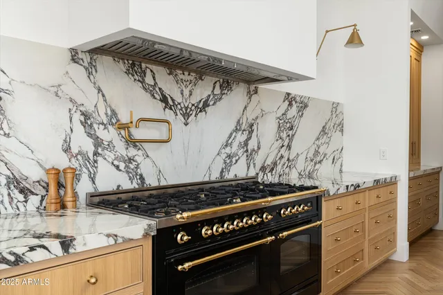 a kitchen with granite countertop a stove and a sink
