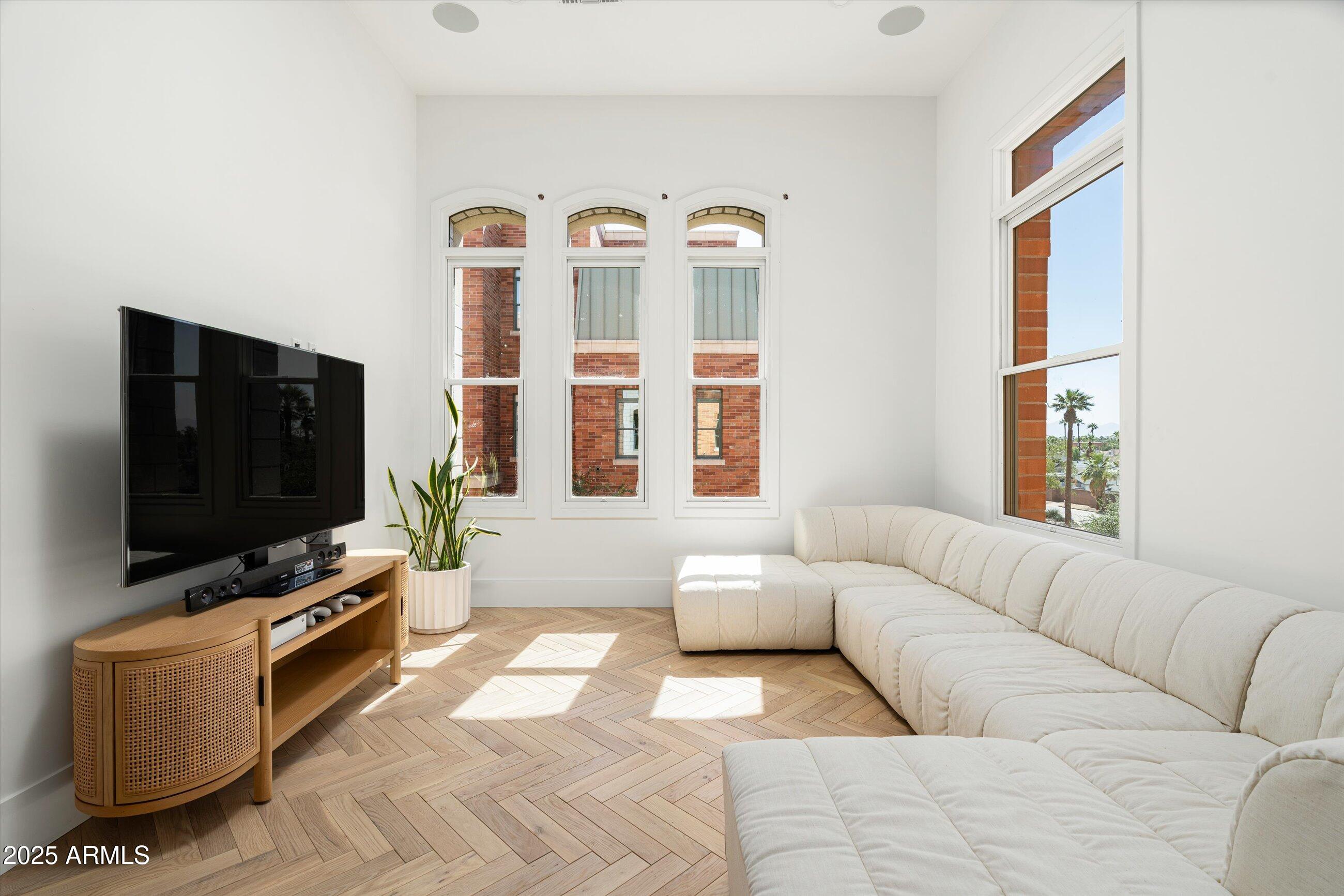 54 West Palm Lane, Unit 54 Phoenix, AZ 85004 - Photo 22 of 31 a living room with furniture and a flat screen tv