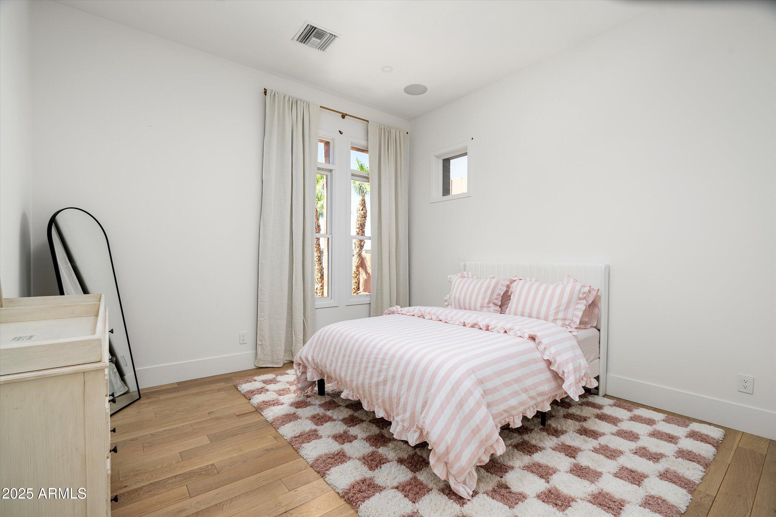 54 West Palm Lane, Unit 54 Phoenix, AZ 85004 - Photo 23 of 31 a bedroom with a bed and a window