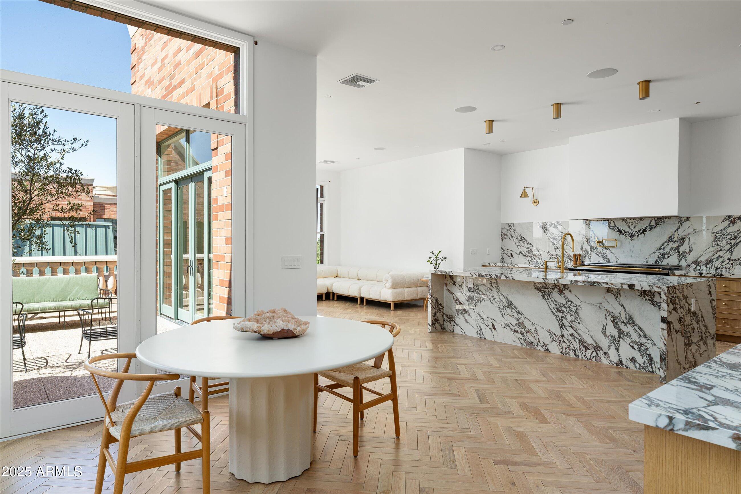 54 West Palm Lane, Unit 54 Phoenix, AZ 85004 - Photo 7 of 31 a view of a dining room with furniture and wooden floor