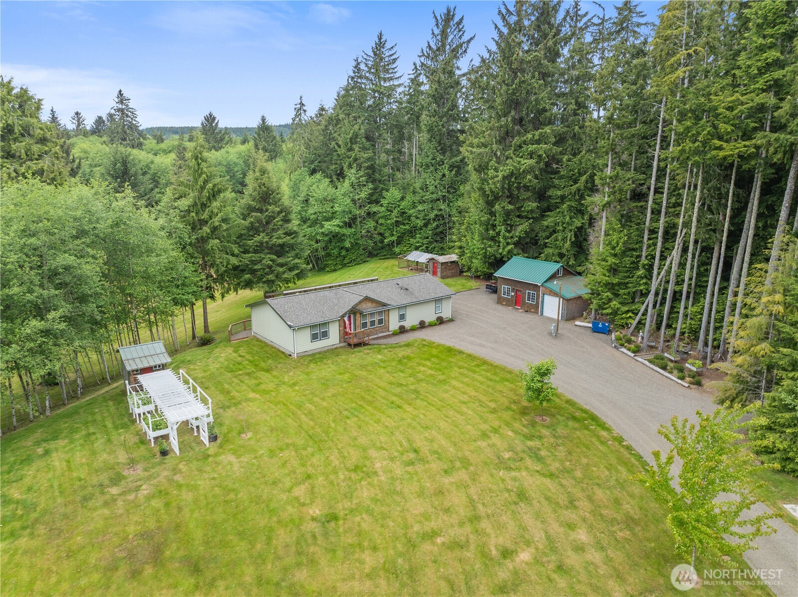 132 River Park Road Forks, WA 98331 - Photo 5 of 40 a backyard of a house with table and chairs