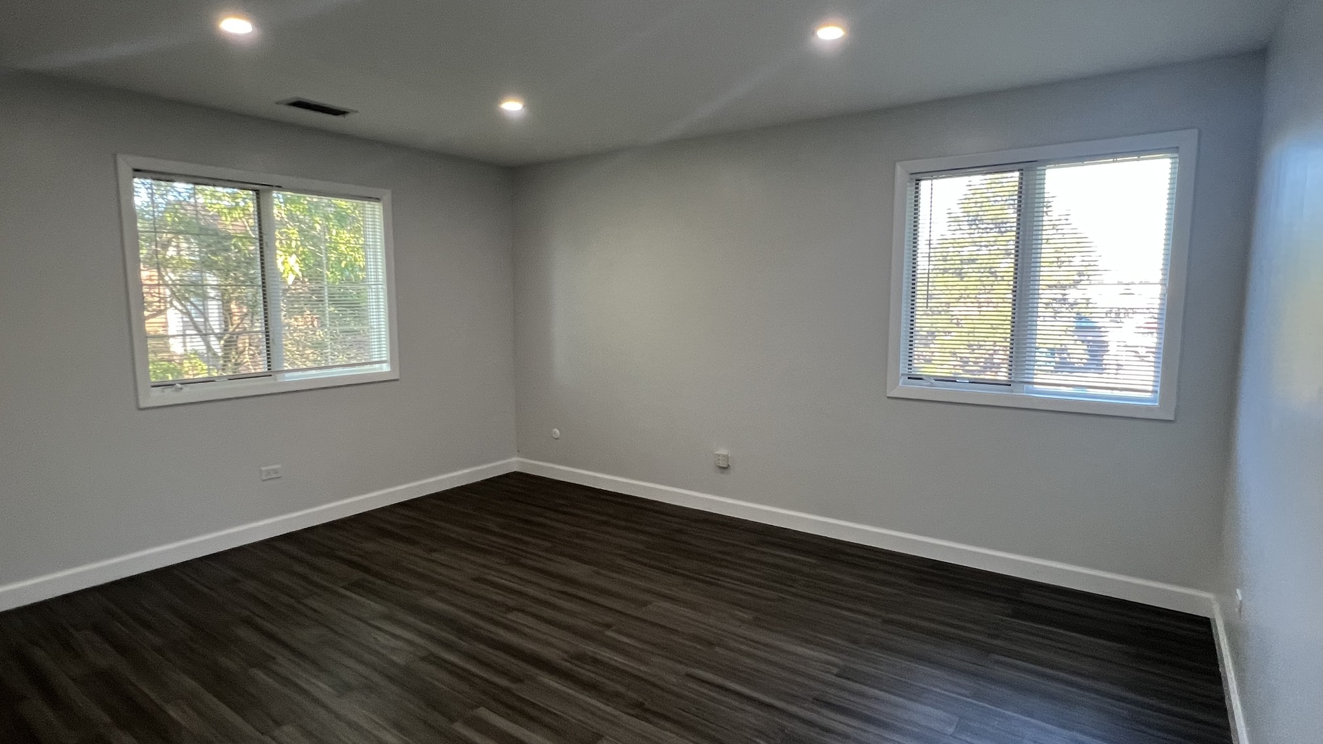 121 Windsor Lane, Unit D Willowbrook, IL 60527 - Photo 14 of 23 a view of an empty room with wooden floor and a window
