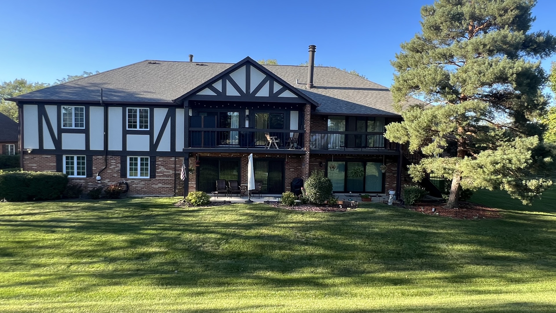121 Windsor Lane, Unit D Willowbrook, IL 60527 - Photo 22 of 23 a front view of a house with a yard table and chairs