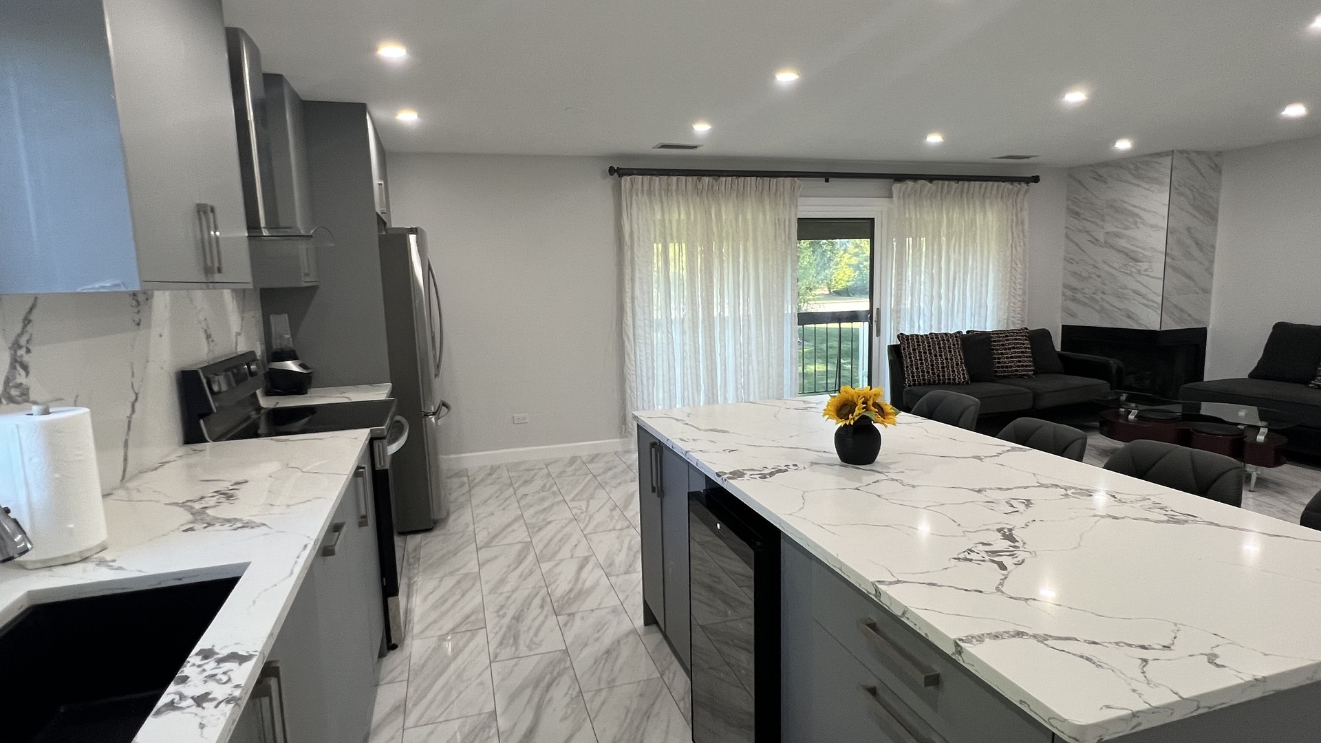 121 Windsor Lane, Unit D Willowbrook, IL 60527 - Photo 4 of 23 a kitchen with stainless steel appliances kitchen island granite countertop a sink a stove and refrigerator