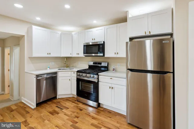 a kitchen with a refrigerator stove and microwave