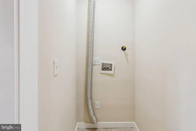 a view of staircase with wooden floor and white walls