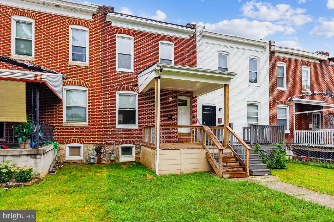 3701 Manchester Avenue Baltimore, MD 21215 - Photo 3 of 34 a view of a house with a yard and a large tree