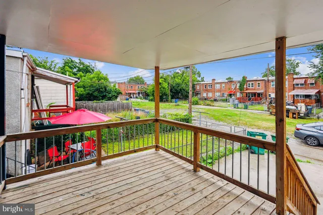 a view of a balcony with wooden floor and outdoor seating