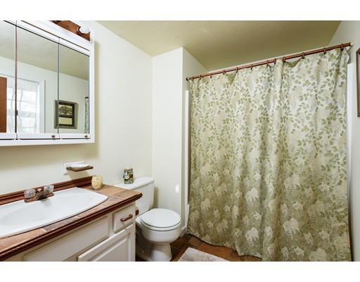 101 Olympia Road Marshfield, MA 02050 - Photo 12 of 24 a bathroom with a granite countertop sink a toilet and shower