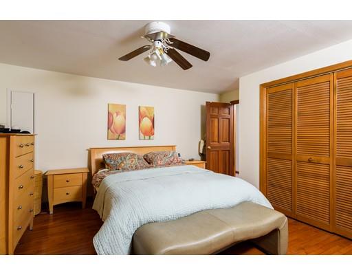 101 Olympia Road Marshfield, MA 02050 - Photo 15 of 24 a bedroom with a bed and a chandelier