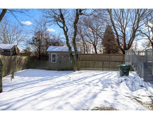 101 Olympia Road Marshfield, MA 02050 - Photo 20 of 24 a backyard of a house with a barbeque and wooden fence