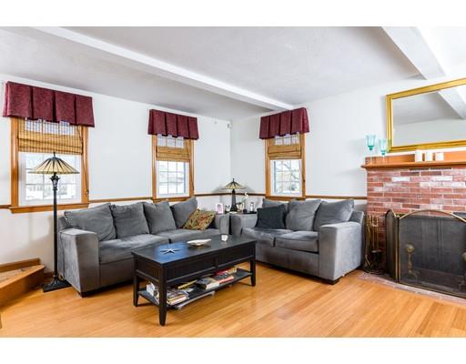 101 Olympia Road Marshfield, MA 02050 - Photo 5 of 24 a living room with furniture a flat screen tv and a fireplace