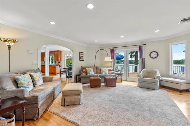 a dining room with furniture a chandelier and wooden floor