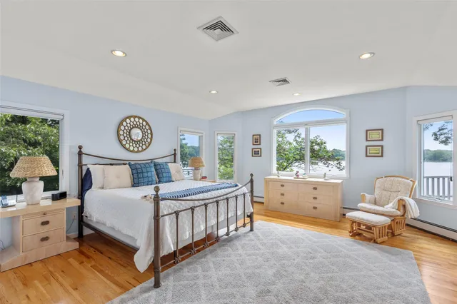 a view of a hallway with wooden floor and windows