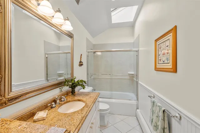 a bedroom with furniture and a large window