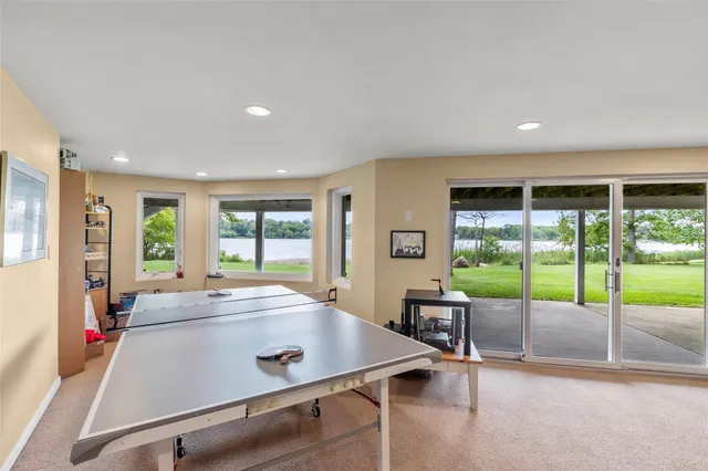 a bathroom with a granite countertop sink a mirror a bathtub and shower