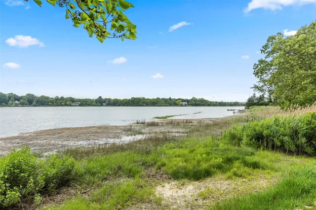 a view of a chairs and table on the wooden deck