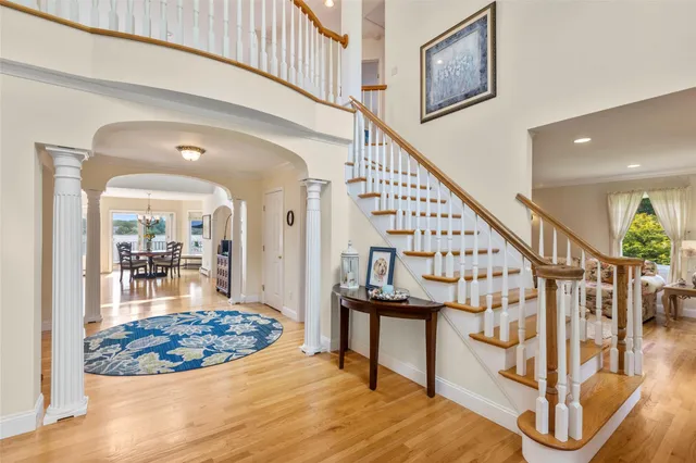 a view of entryway and hall with wooden floor