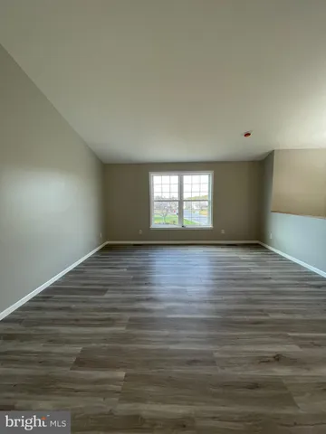 a view of wooden floor and windows in a room
