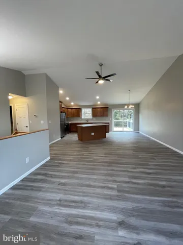 a view of kitchen and hall with wooden floor