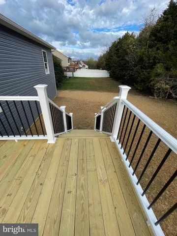 a view of outdoor space with deck and yard