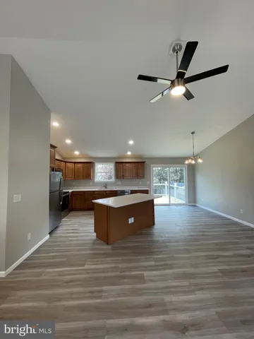a kitchen with kitchen island a sink stainless steel appliances and cabinets