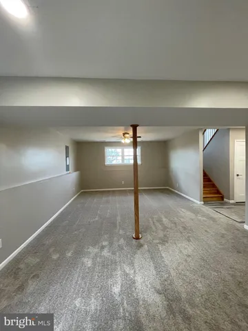 a view of roof deck with chair and tables