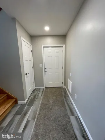 a house with large trees in the background