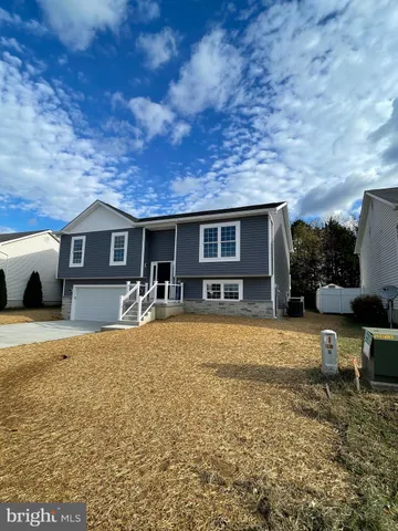 a house view with a sitting space and garden