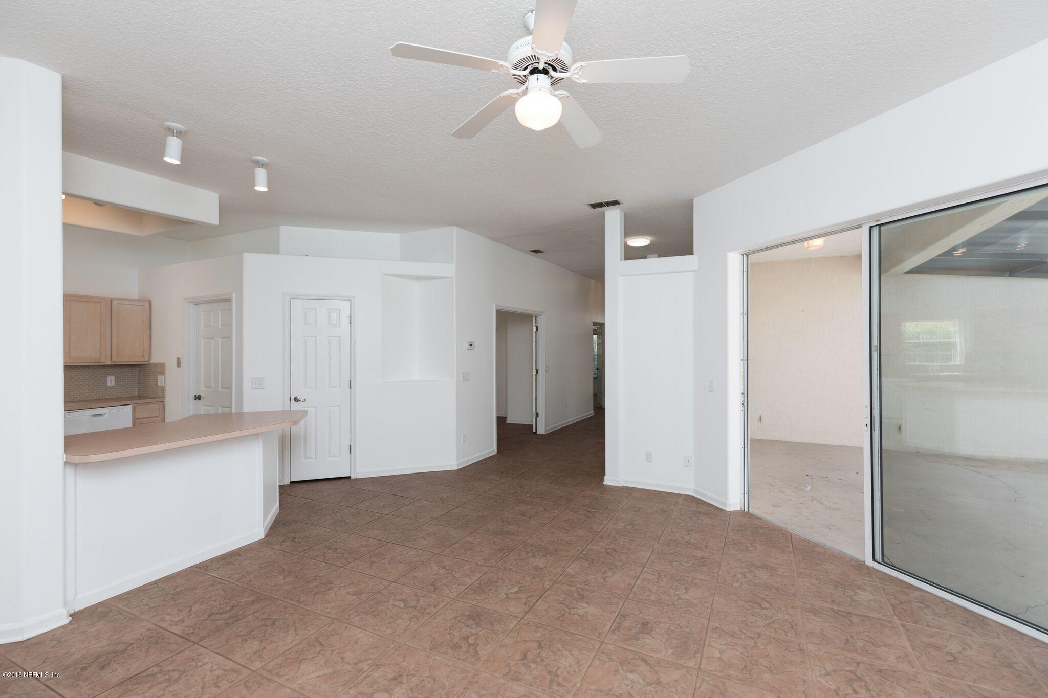 128 Cedar Ridge Circle St. Augustine, FL 32080 - Photo 12 of 37 a view of a kitchen with a sink and a refrigerator