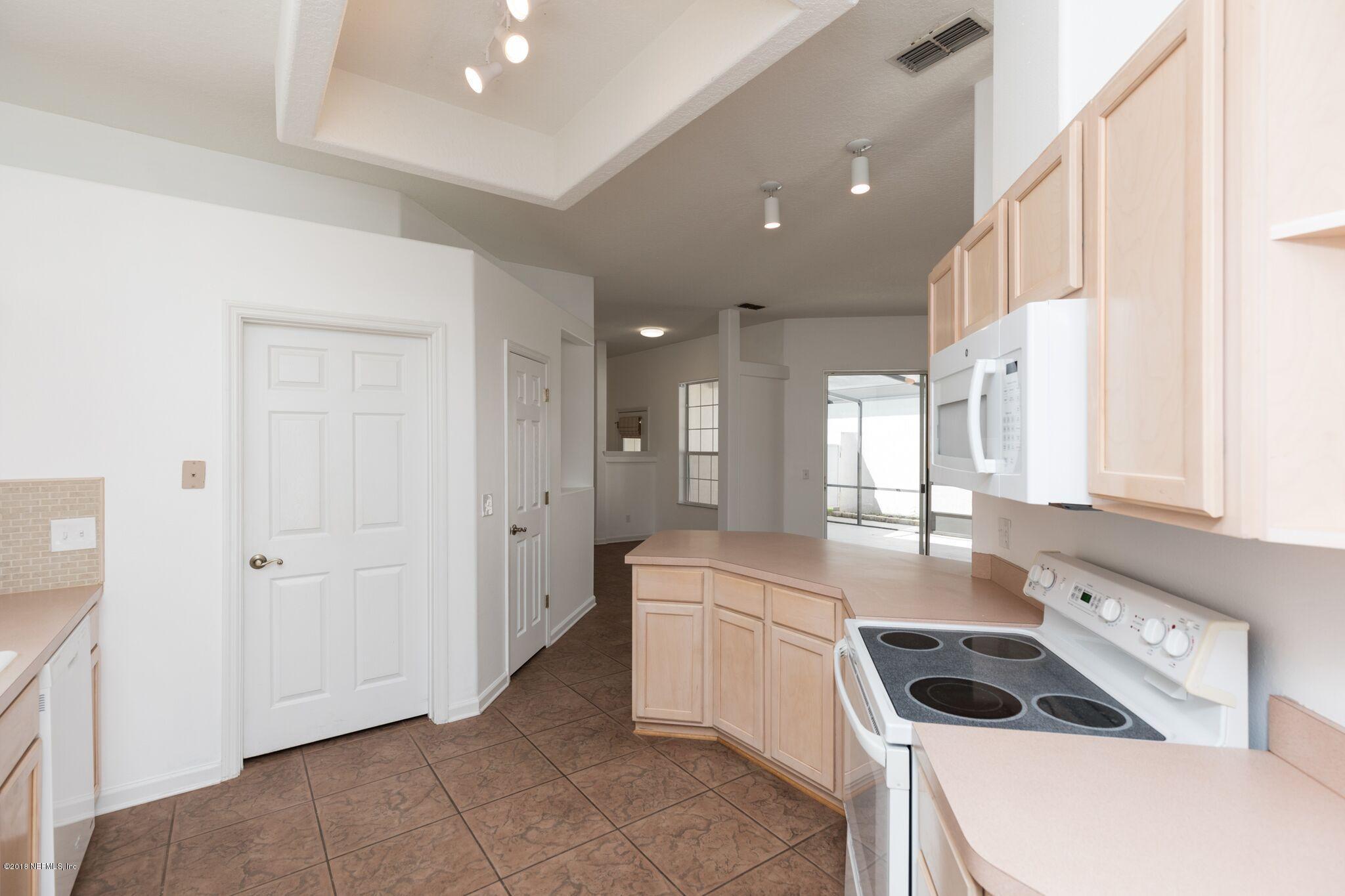 128 Cedar Ridge Circle St. Augustine, FL 32080 - Photo 14 of 37 a kitchen with a sink cabinets and appliances