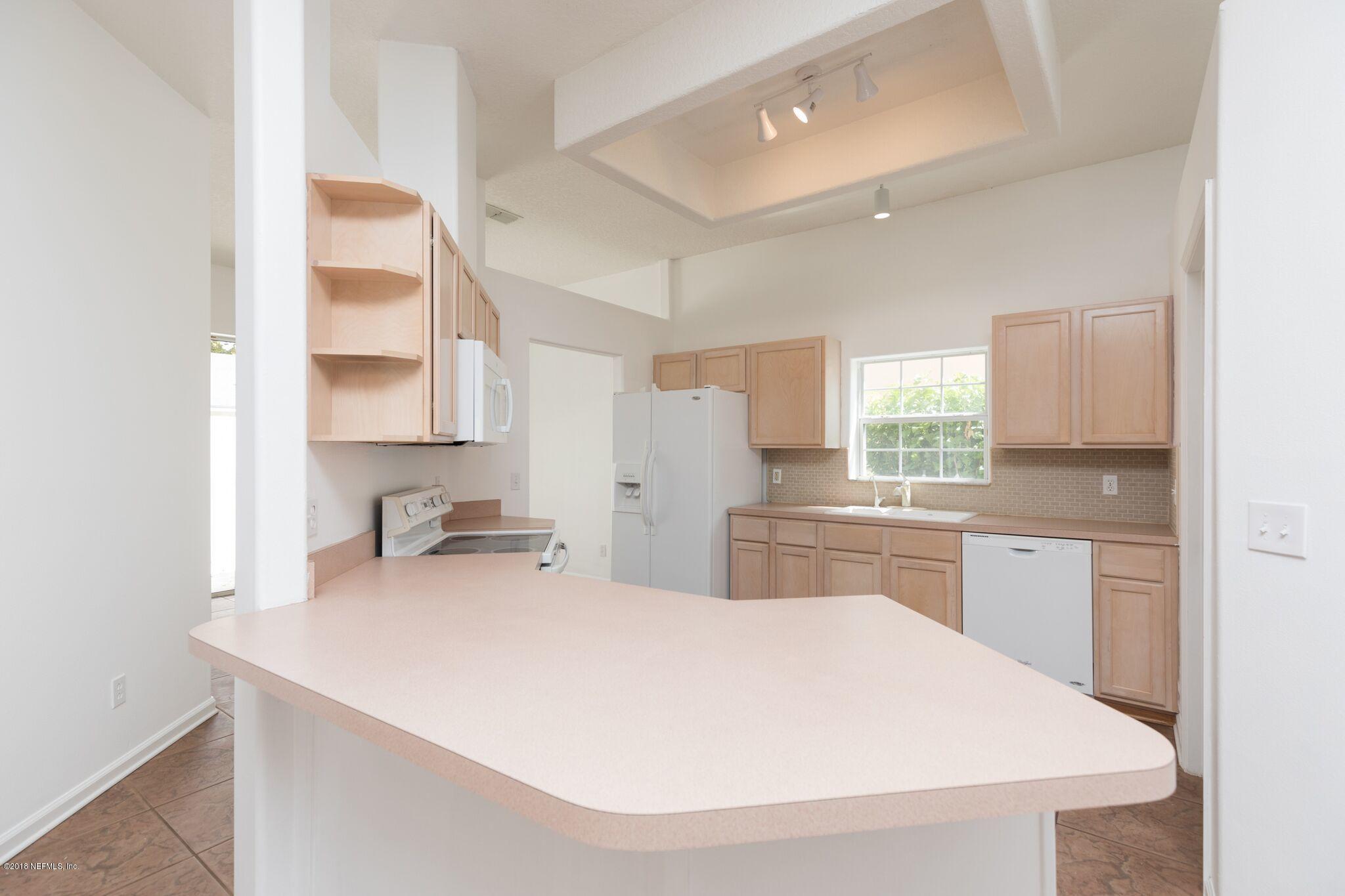 128 Cedar Ridge Circle St. Augustine, FL 32080 - Photo 16 of 37 a kitchen with a sink a stove and cabinets