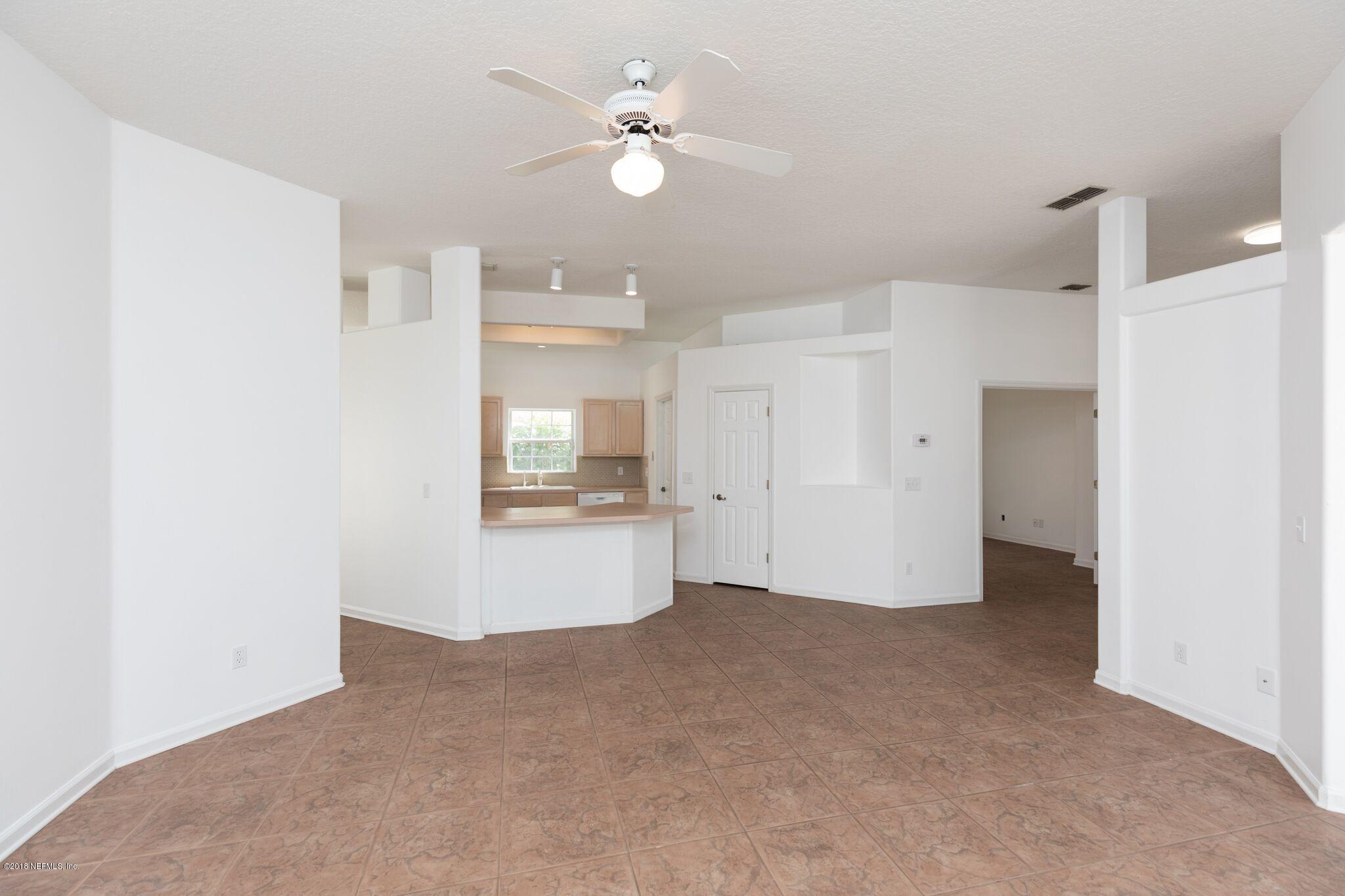 128 Cedar Ridge Circle St. Augustine, FL 32080 - Photo 18 of 37 a view of an empty room with a kitchen